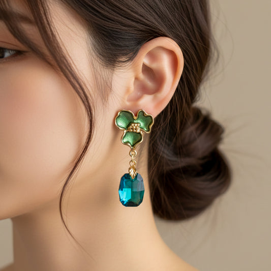 Green enamel flower drop earrings with gold-tone hooks and teal-green crystal dangle