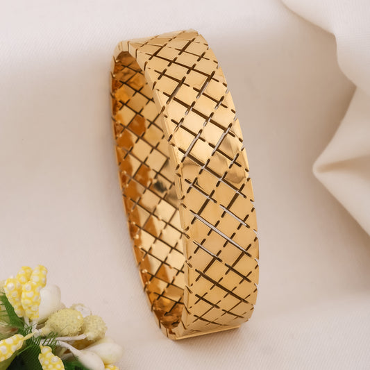 Gold wide kada bangle with geometric quilted cross-hatch pattern, chunky cuff