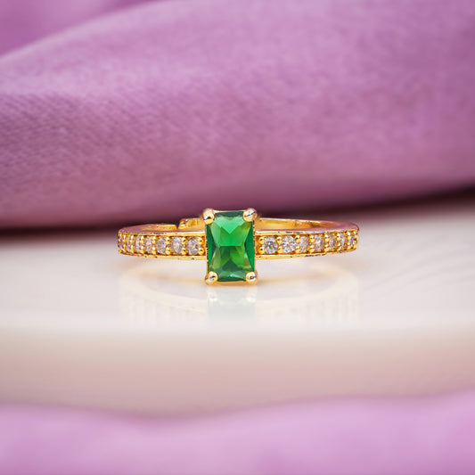 Gold ring with emerald green rectangular solitaire and pavé band