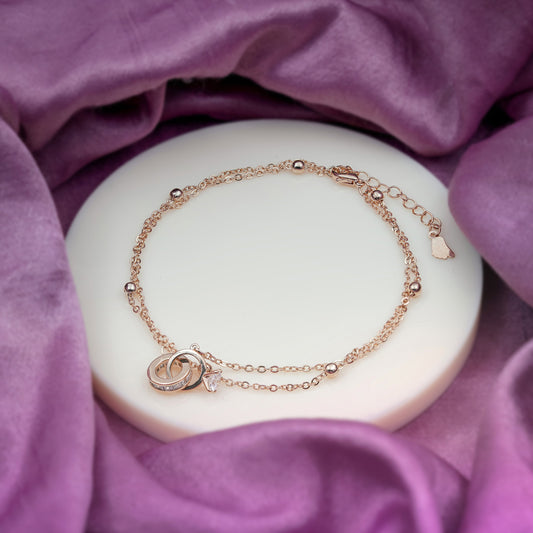 Rose-gold stainless steel anklet with heart-and-loop pendant and leaf charm