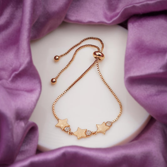 Rose gold star CZ slider bracelet laid flat, five star charms with rhinestone centers