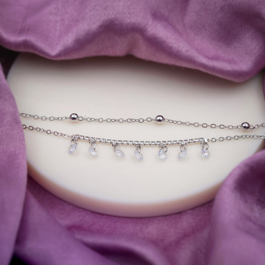 Silver anklet with row of dangling clear crystal teardrop charms and round beads