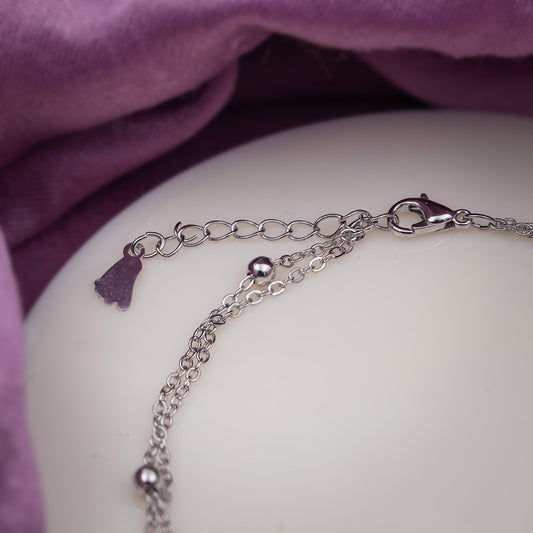 Stainless steel anklet with layered chain and round ring charms with crystal accents