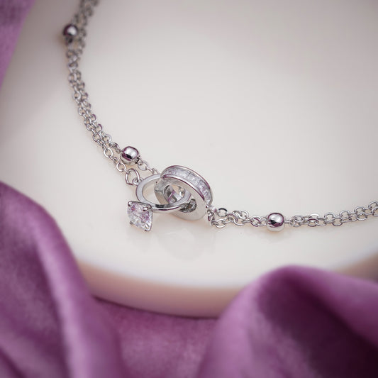 Silver-tone anklet with heart locket charm, small square crystal, and bead-like links