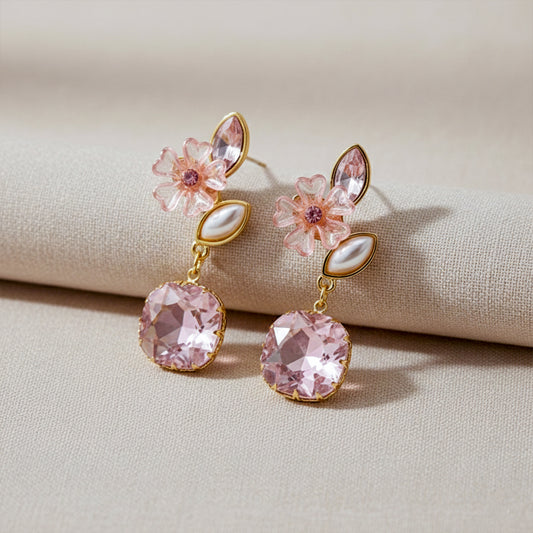 Blush drop earrings with pink flower, petal charms, and faceted cushion-stone dangles