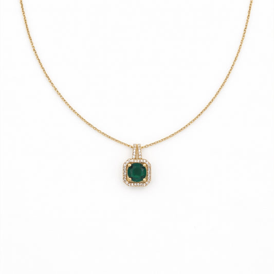 Gold-tone chain necklace with square emerald-green pendant framed by crystals