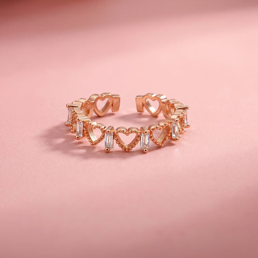 Rose gold open-heart eternity ring with baguette CZ accents and adjustable style