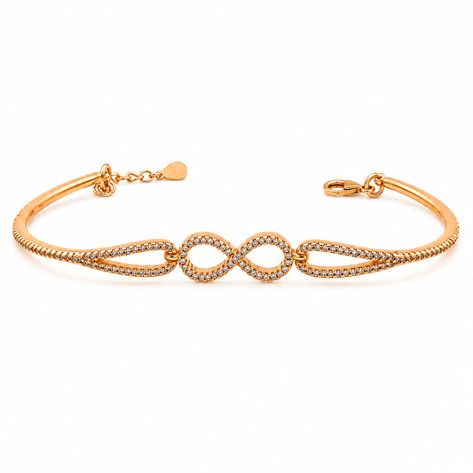 Gold CZ infinity knot bangle bracelet with open cuff and clasp closure
