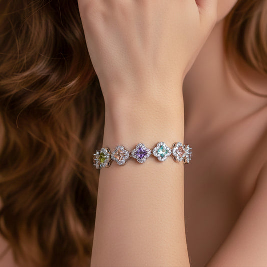 Pastel clover tennis bracelet in silver tone worn on wrist with multicolor stone links
