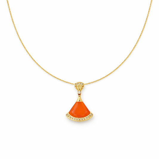 Gold chain pendant necklace with orange coral teardrop charm and crystal setting.