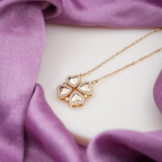 Gold-tone clover heart pendant detail with CZ stones on the chain
