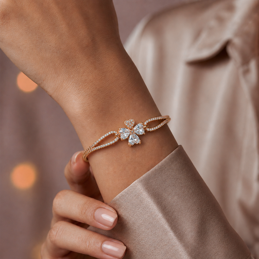 Rose gold CZ flower bangle bracelet worn on wrist with four-petal center