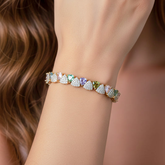 Tennis bracelet on wrist with gold-tone multicolor oval stones