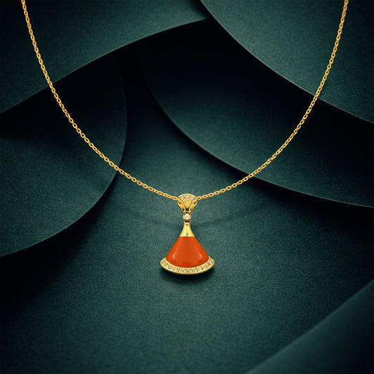 Gold pendant necklace with orange coral teardrop drop charm and crystal halo top.
