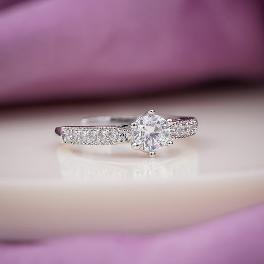 Silver six-prong solitaire ring with crystal pavé band