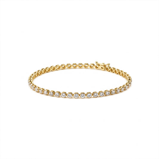 Gold-tone rhinestone tennis bracelet with continuous circular stones, flat lay.