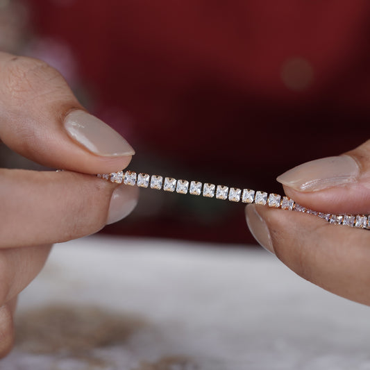 Gold-tone tennis bracelet with sparkling stone row, clasp area close-up