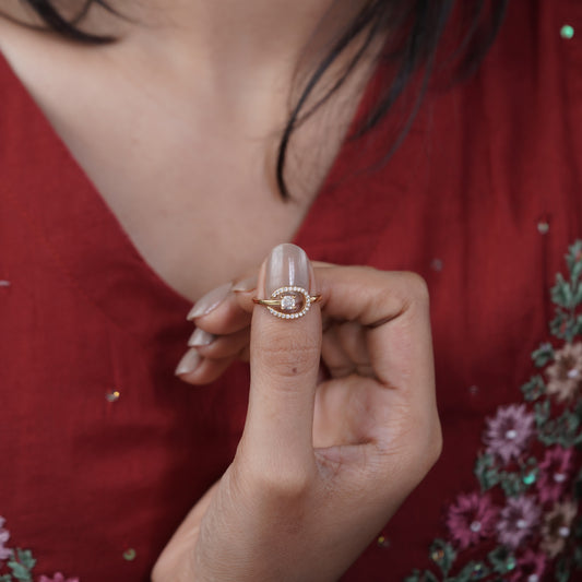 Rose gold crystal crescent solitaire bypass ring on a woman's finger