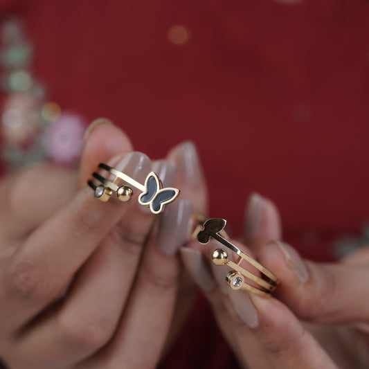 Gold-tone triple-bar kada bangle with butterfly charm and bead-like round details