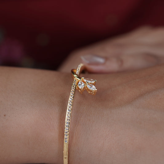 Gold-toned CZ kada bangle with marquise flower charm on a slim band