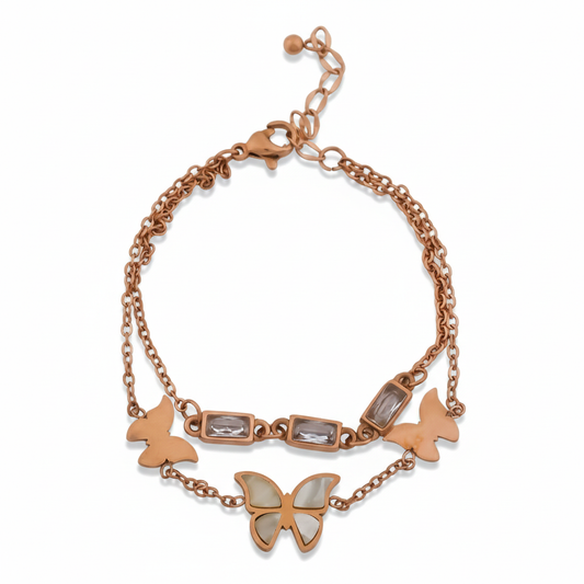 Rose-gold charm bracelet featuring butterfly pendants and square crystal link beads