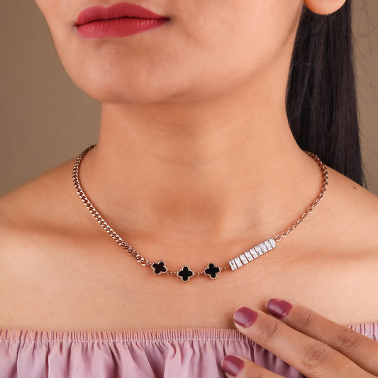 Rose-gold curb necklace on model with black clover charms and CZ baguette bar