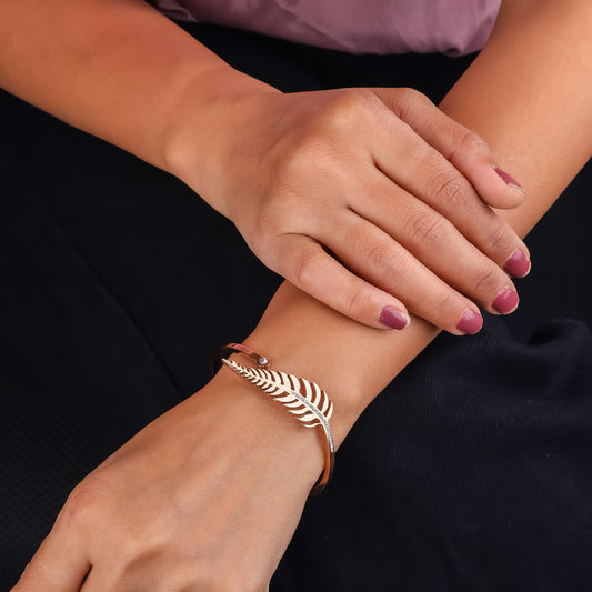 Feather leaf rose gold cuff bangle on wrist with small crystal details