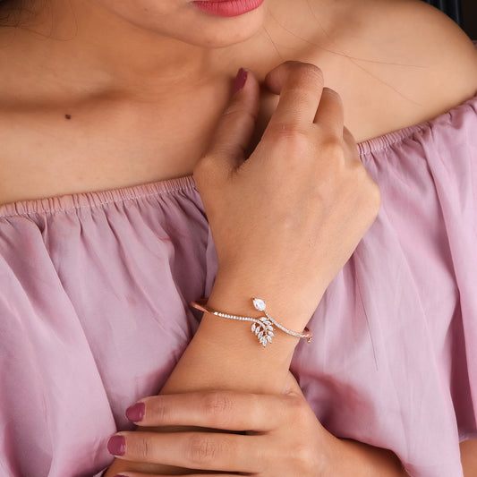 Rose gold crystal floral kada bangle on wrist, crystal-studded design with central stone