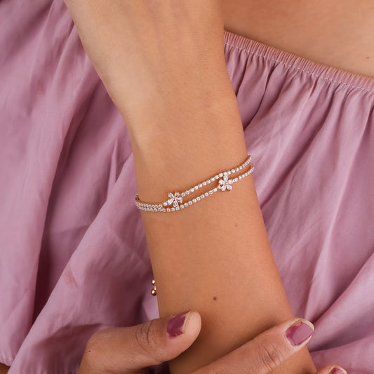 Adjustable slider bracelet with gold-tone chain and clear rhinestone links on wrist