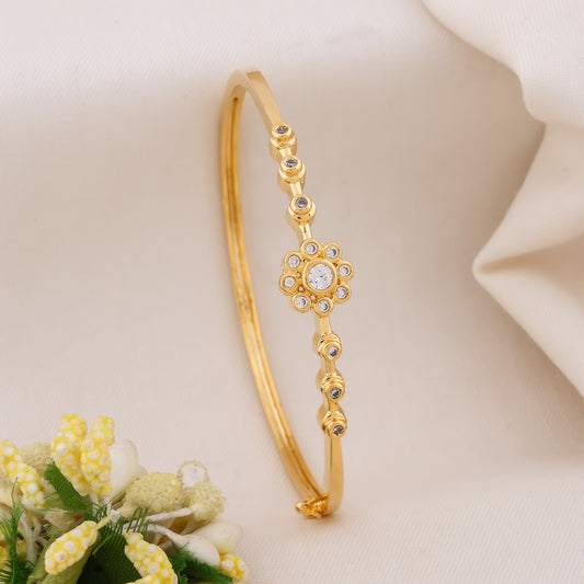 Gold kada bangle with flower crystal motif and hanging bead drops