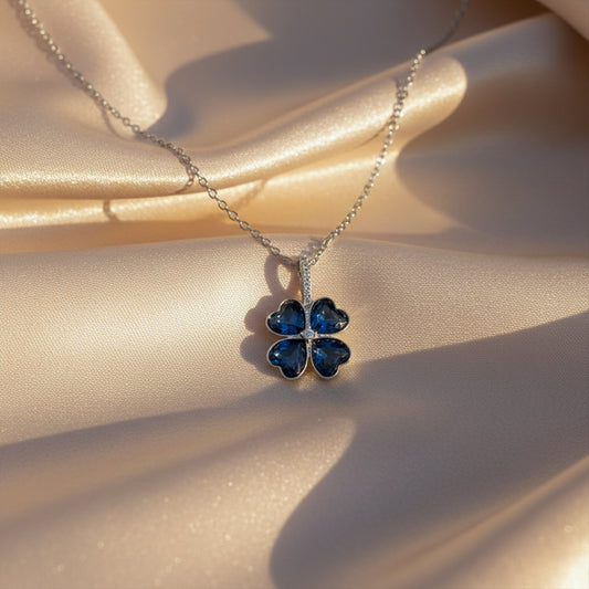 Silver-tone pendant necklace with blue flower four-petal charm on chain